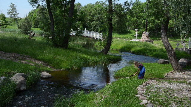 girl comes river takes off sandals rises dress wade other side