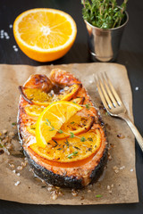 Grilled salmon with thyme on chalkboard