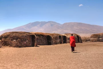  Massai huts with a woman in red in back view © Yü Lan