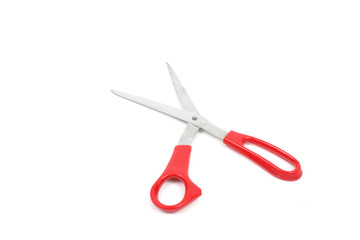 Scissors with red handles over white