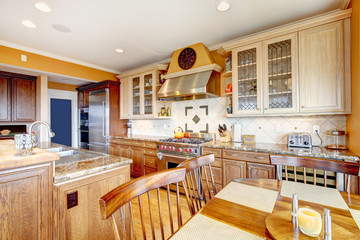 Brown and yellow kitchen with dining table set