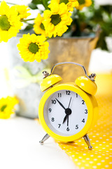 Yellow alarm clock with flowers