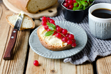 Homemade bread with butter and red currant