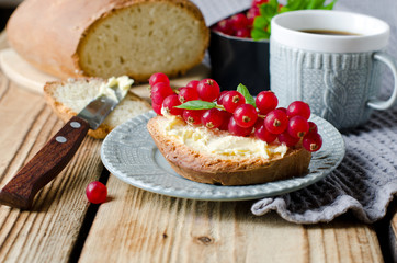 Homemade bread with butter and red currant