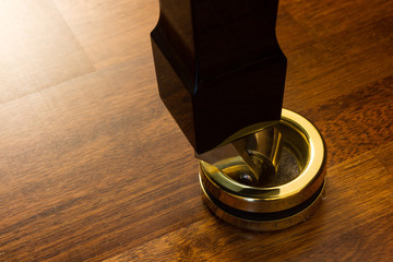 Grand piano leg wheel in a golden caster cup