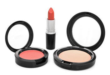 Lipstick, blush and face powder on white background