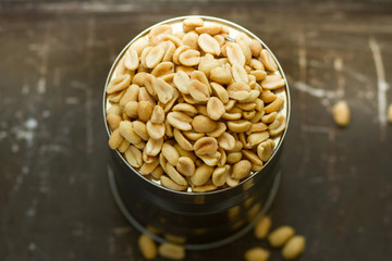 salted peanuts, nuts in a small metal bowl with wood background