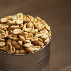 salted peanuts, nuts in a small metal bowl with wood background
