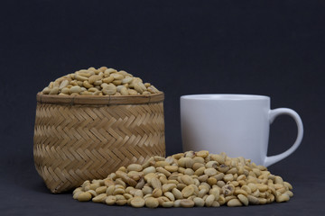 Coffee beans on wicker Basket and coffee mugs.