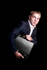 Funny businessman stolen portfolio with money. Isolated on black