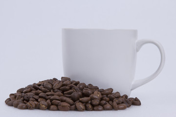 roasted coffee beans and coffee mugs.