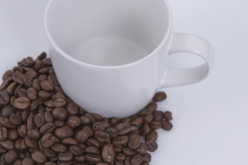 roasted coffee beans and coffee mugs.