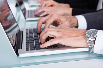 Businesspeople Hand's Typing On Laptop