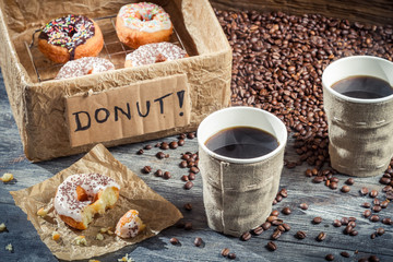 Box full of donuts with coffee for two