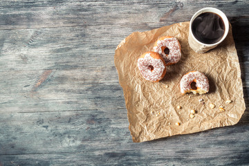 Fototapeta na wymiar Donuts, coffee and wooden table background