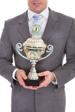 Businessman Holding Trophy