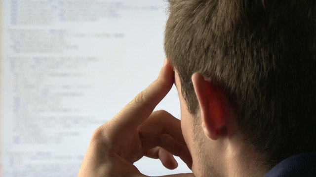 Young computer programmer at his desk