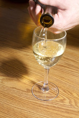 Pouring a glass of white wine