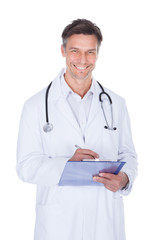 Male Doctor Writing On Clipboard