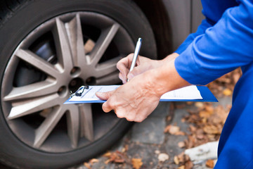 Worker Maintaining Car Records