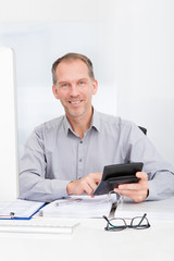 Businessman Using Calculator
