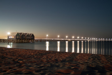 A long jetty with light posts at twilight