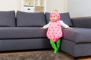 Baby with cute strawberry dressing at home