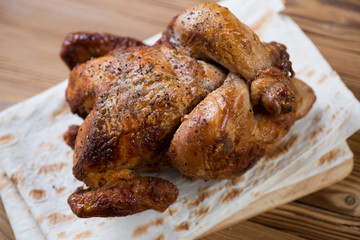 Smoked chicken with spices on pita, high angle view