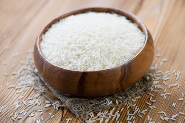 Wooden bowl with basmati kernels, horizontal shot