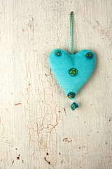 Blue  heart  hand made on a wooden background
