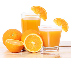 Orange juice and slices on wood