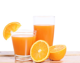 Orange juice and slices on wood