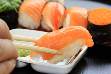 chopsticks with japanese sushi