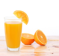 Orange juice and slices on wood