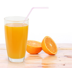 Orange juice and slices on wood