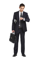 Full-length portrait of businessman handing briefcase - 60907404