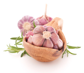Garlic cloves in wooden bowl isolated on white background