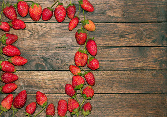 Strawberry frame on wooden board