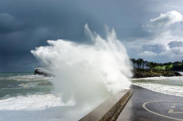 big wave breaking on breakwater