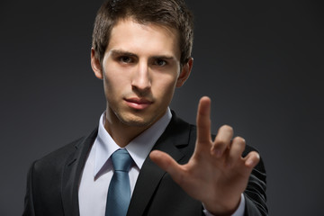 Portrait of businessman forefinger gesturing