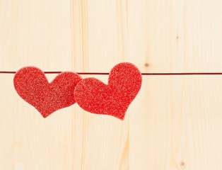 two decorative red hearts hanging, concept of valentine day