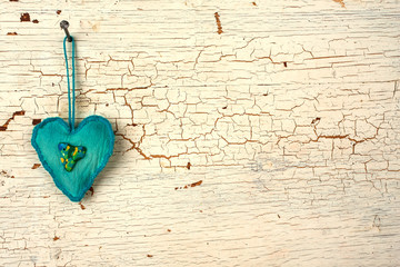 Blue valentines handmade heart on a  white old wooden door