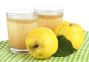 Sweet quince with juice on table on white background