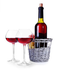 Wineglasses with red wine, and bottle isolated on white