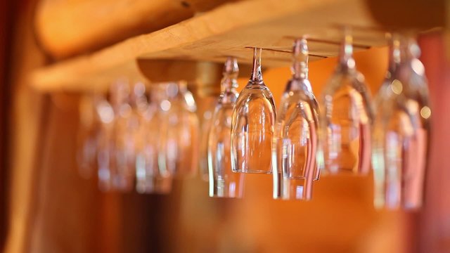 Wine glasses hanging upside down in the bar