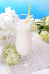 Milk shake on table on light blue background