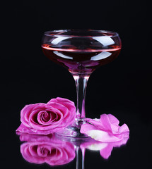 Composition with pink sparkle wine in glass and  rose isolated