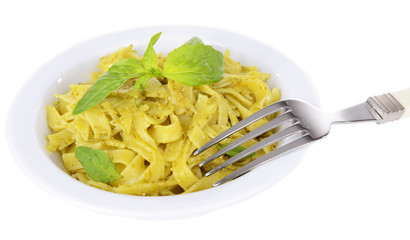 Delicious pasta with pesto on plate isolated on white