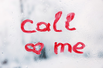 Inscription lipstick on glass on bright background