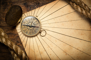 Old compass and rope on vintage paper.